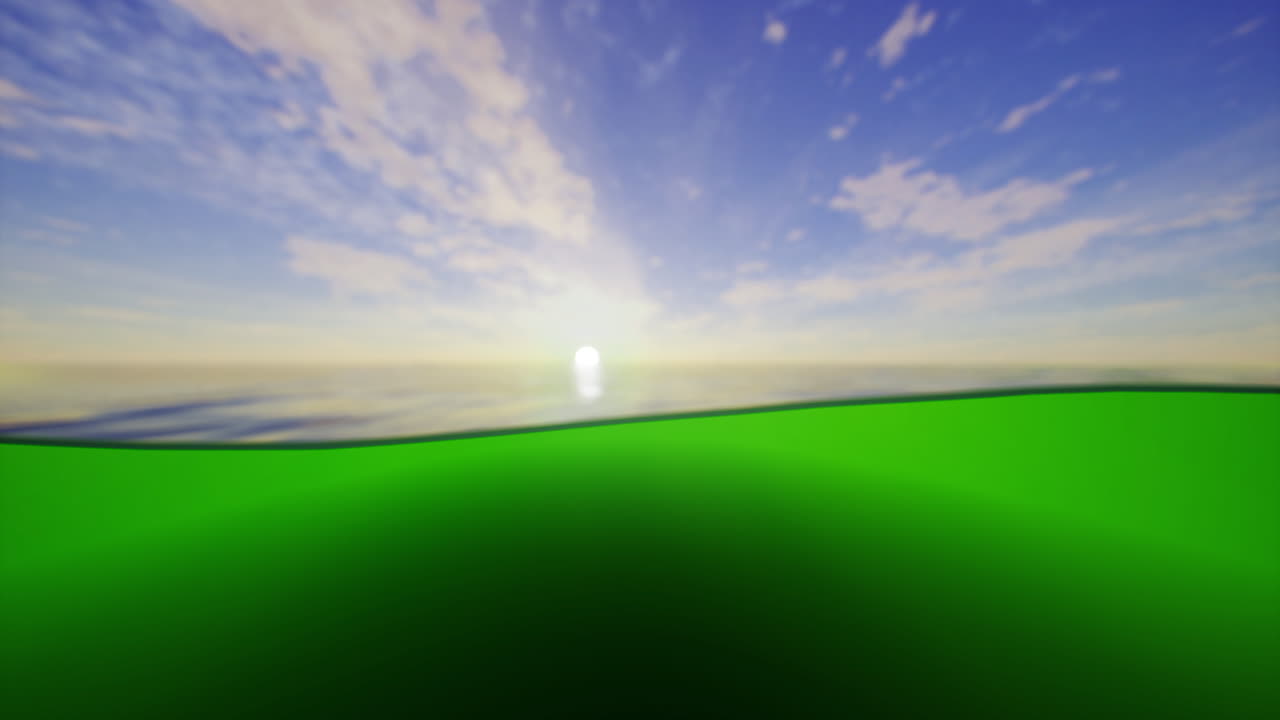 Vibrant sunrise over calm ocean with green foreground