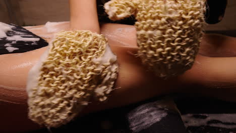 woman receiving a body scrub