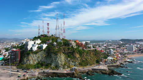 Malecon-de-Mazatlan-and-the-Icebox-hill,-sunny-day-in-Mexico---Aerial-view