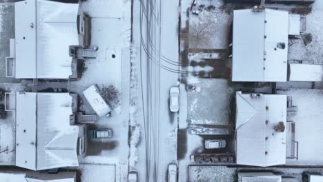 top down aerial view of a snow covered neighborhood in suburban america