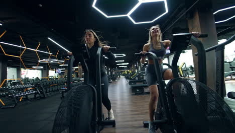 women exercising on air bikes in a modern gym