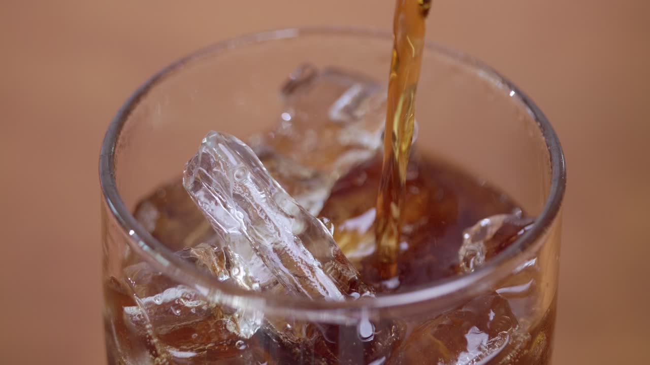 A refreshing drink is being poured over ice showcasing a cozy home bar atmosphere and the joy of hydration