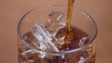a refreshing drink is being poured over ice showcasing a cozy home bar atmosphere and the joy of hydration