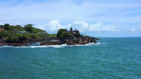 Pura-Tanah-Lot-In-Bali,-Indonesia-At-Daytime---aerial-drone-shot