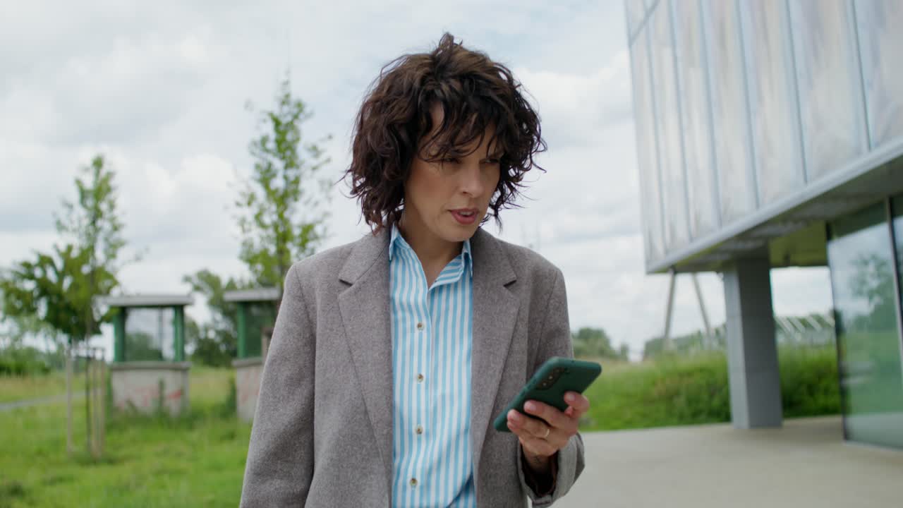 Businesswoman using smartphone outdoors