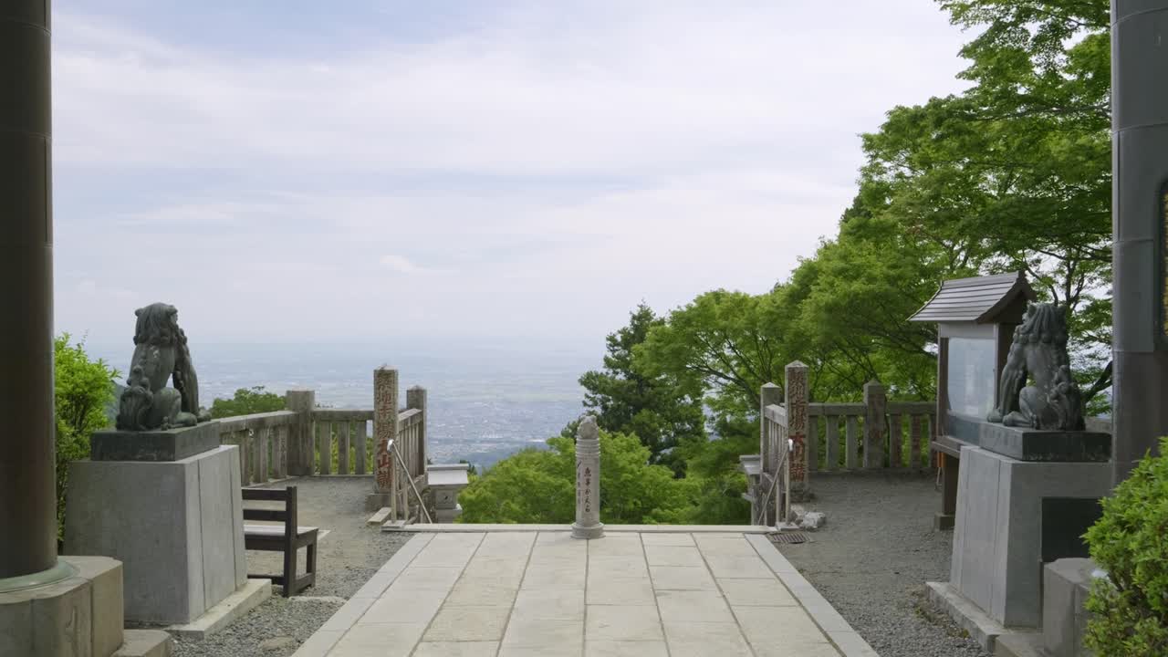 Perfect dolly over Stone Torii gate on top of mountain with panoramic view