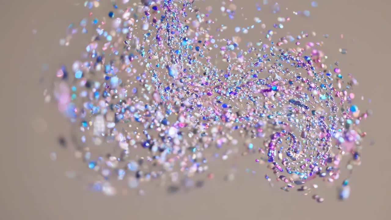 A dynamic video captures swirling, colorful confetti in mid-air from a side angle