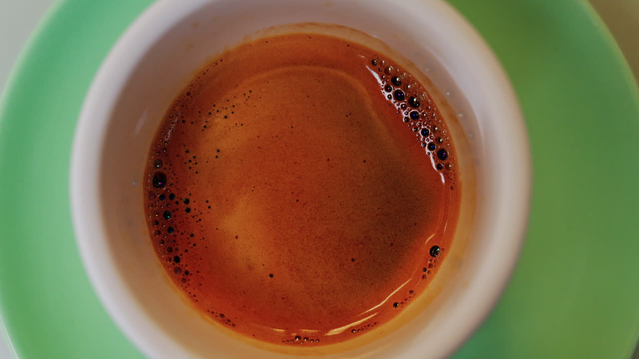 Close up of an espresso cup on a green plate