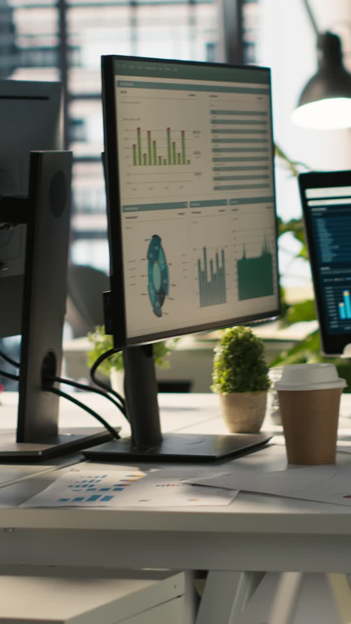 Vertical video Business graphs and performance metrics on monitors in office