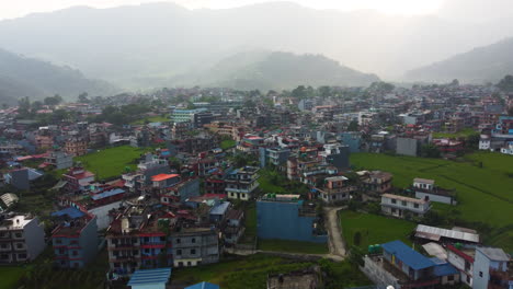 tall ramshackle apartment buildings gathered at base of mountains in pokhara nepal