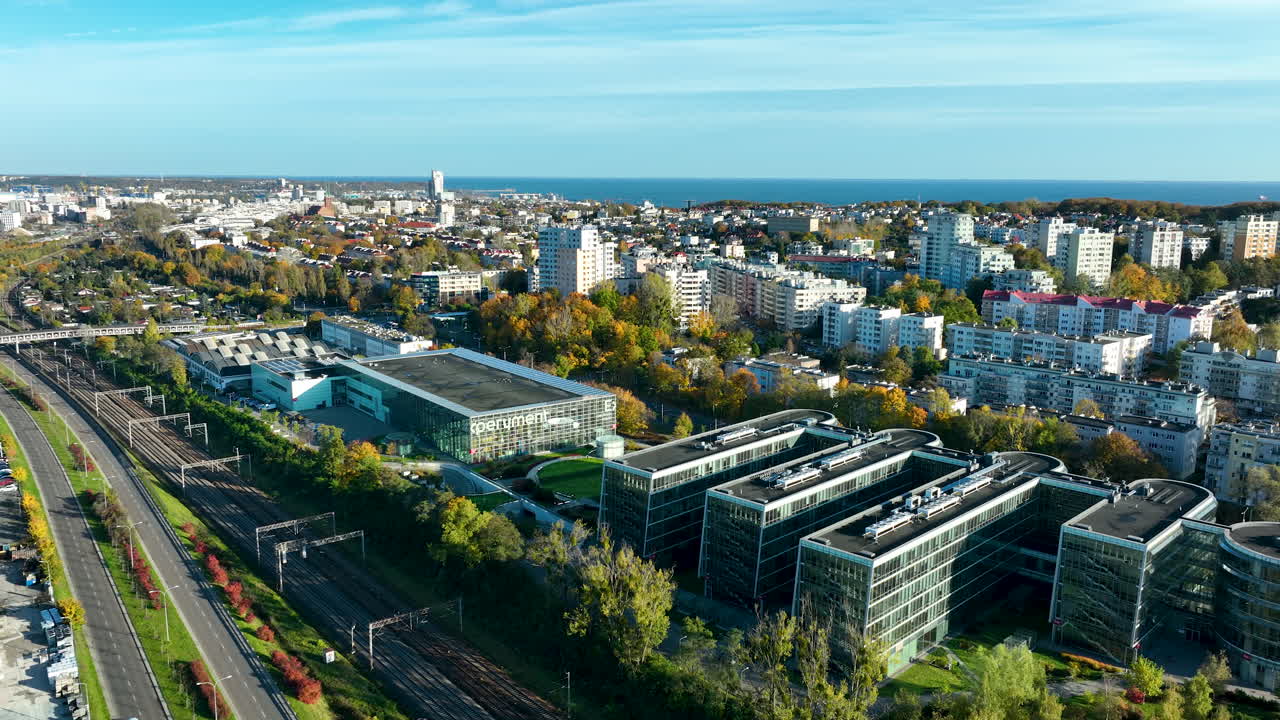 Drone aerial of business park and railway lines leading toward the Baltic Sea in Gdynia, Poland