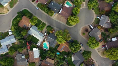 aerial birds eye shot rising over suburbs and forest of sunny california, usa