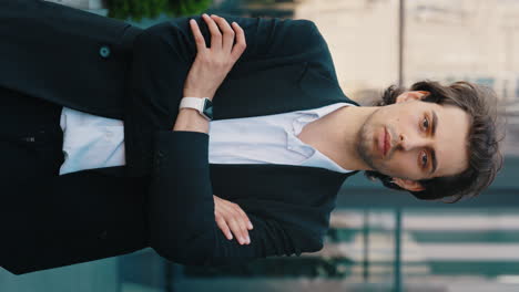confident young businessman in suit with arms crossed