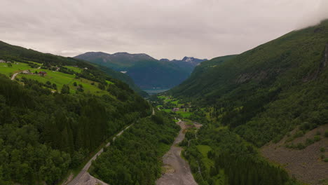 Lush-valley-with-river-on-Norway-West-Coast-flowing-towards-fjord