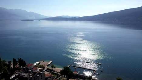 over coastal town and boat marina towards sea bay clean water
