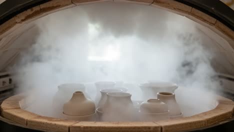 the art of ceramics: a glimpse inside the kiln as steam erupts around freshly crafted pottery, signifying the transformation of clay into works of art