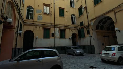 exploring a historic courtyard with parked cars