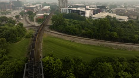 aerial view of freight train moving in urban columbus ohio on a foggy smoky day