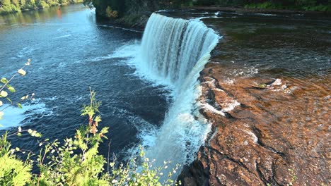 view over waterfall edge of tahquamenon upper waterfall, upper peninsula, michigan, autumn