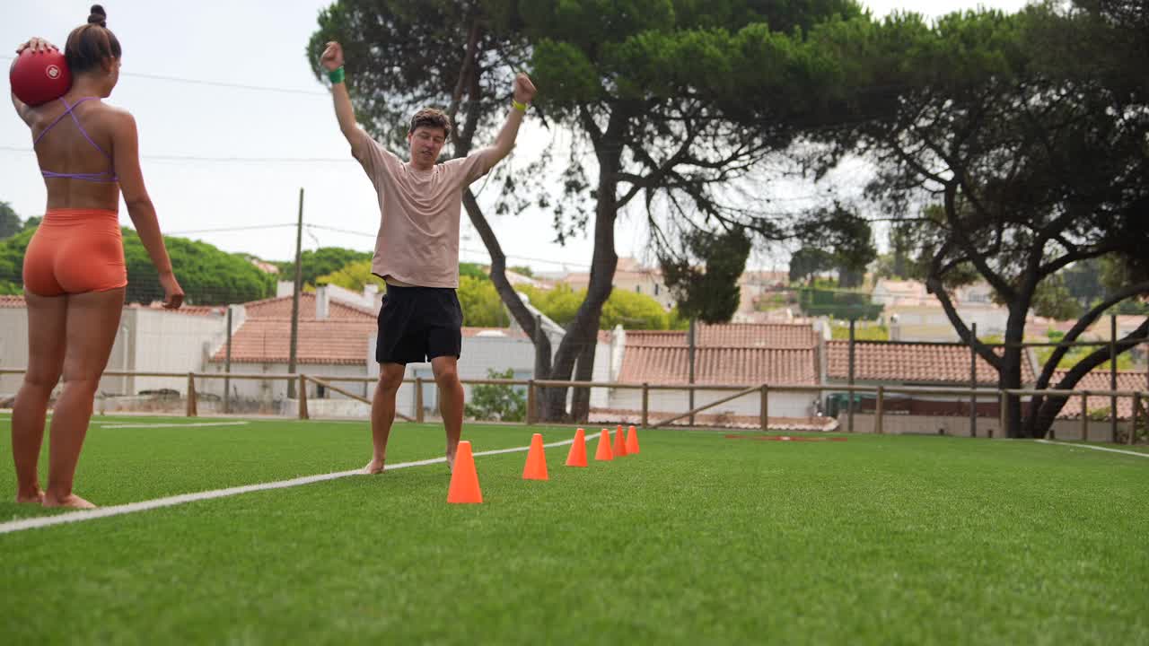 People doing agility training on artificial turf