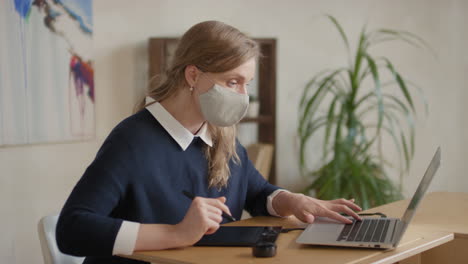 woman working from home on a laptop and digital tablet