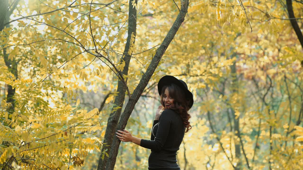 Girl walking in park. Attractive woman walking in autumn forest