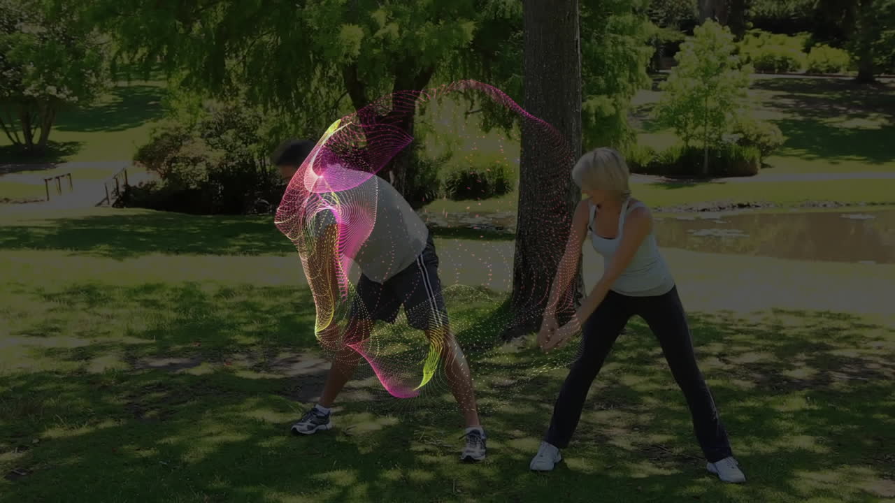 People stretching in park with colorful digital wave animation over them