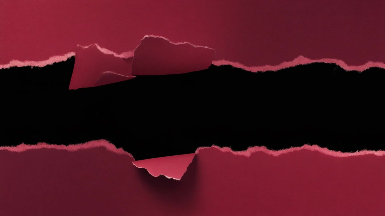 Red Paper Ripped to Reveal Black Background
