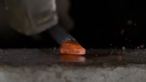 close-up-super-slow-motion-shot-of-a-blacksmith-shaping-steel-on-an-anvil