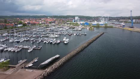 A marina in aabenraa, denmark, with boats, waterfront, and surrounding buildings, aerial view