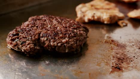 close-up of a delicious hamburger meat cooking on a metal plate