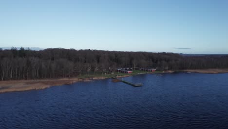 aerial view of skanderborg lakein denmark, fishing water, beautiful lake and forest - truck shot