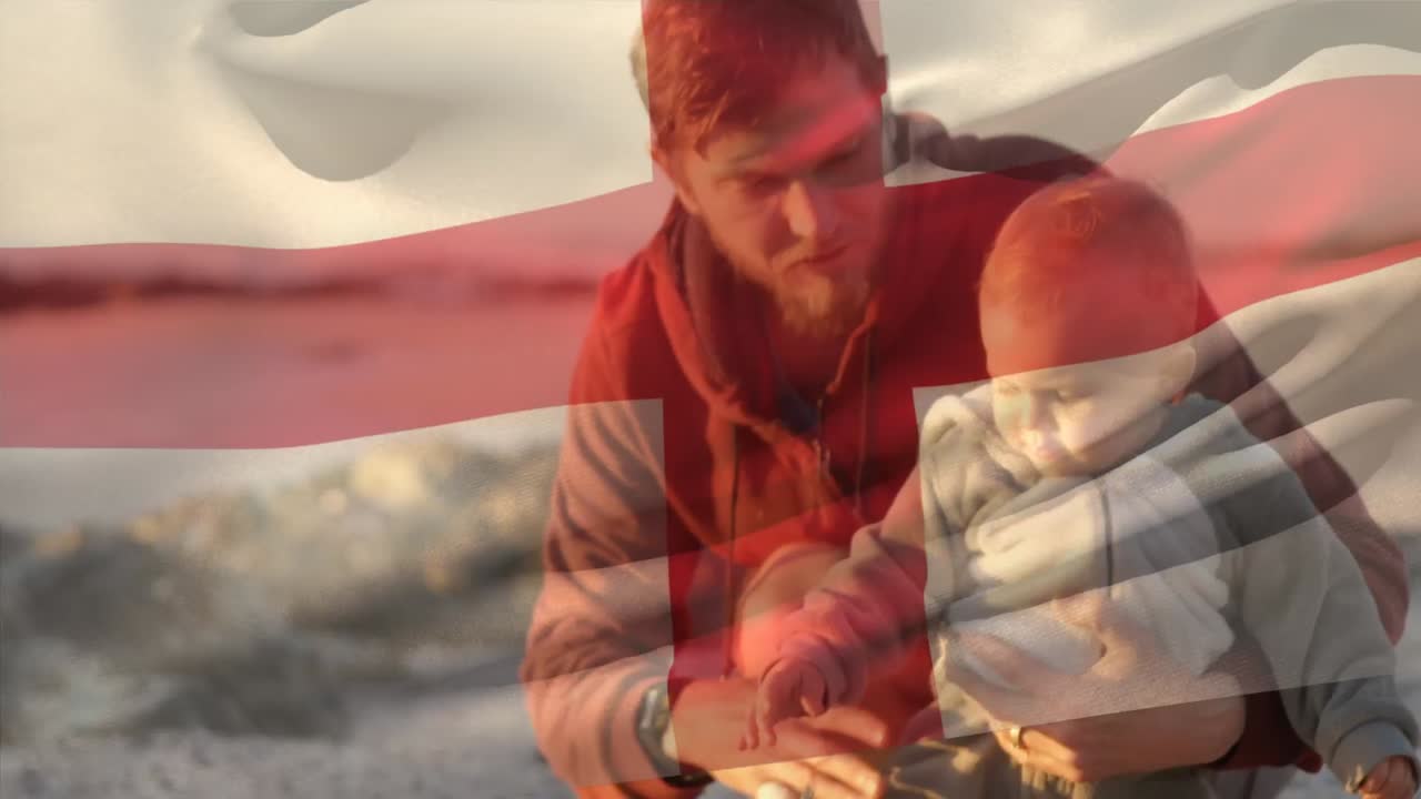 해변에서 아이를 안고 있는 백인 아버지 위에 영국  ⁇ 발의 애니메이션