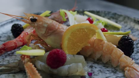 macro shot of a dish full of scampi, salat and fish - 03