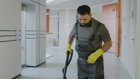 arabic cleaning man cleaning with pressure water machine inside an office building