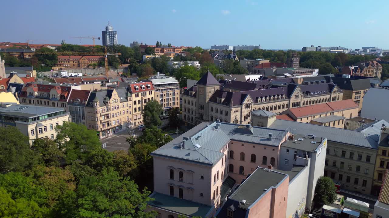 city of halle saale in germany, showing the historic post office building surrounded by apartment buildings. fly reverse drone