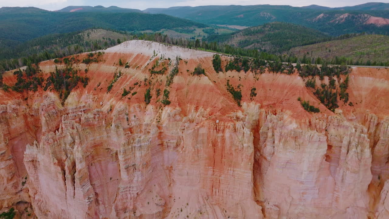 Bryce National Park canyons of coral color. Wonderful mountainous landscape covered with pine tree forests. Aerial view.