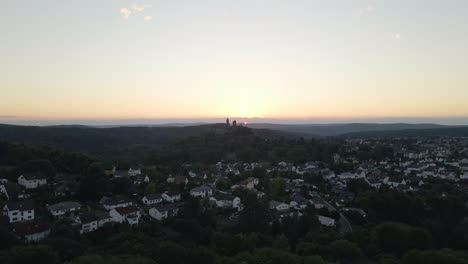 Toma-Aérea-Ascendente-Sobre-El-Casco-Antiguo-Con-El-Castillo-De-Braunfels-Sentado-En-El-Horizonte