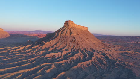 Factory-Butte-and-surrounding-landscape-at-sunrise,-Utah,-aerial-showing-lines,-arteries,-ridges-and-veins-of-mountain