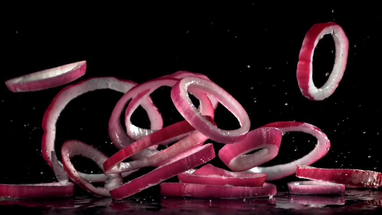 Fresh Red Onion Rings Falling in Slow Motion
