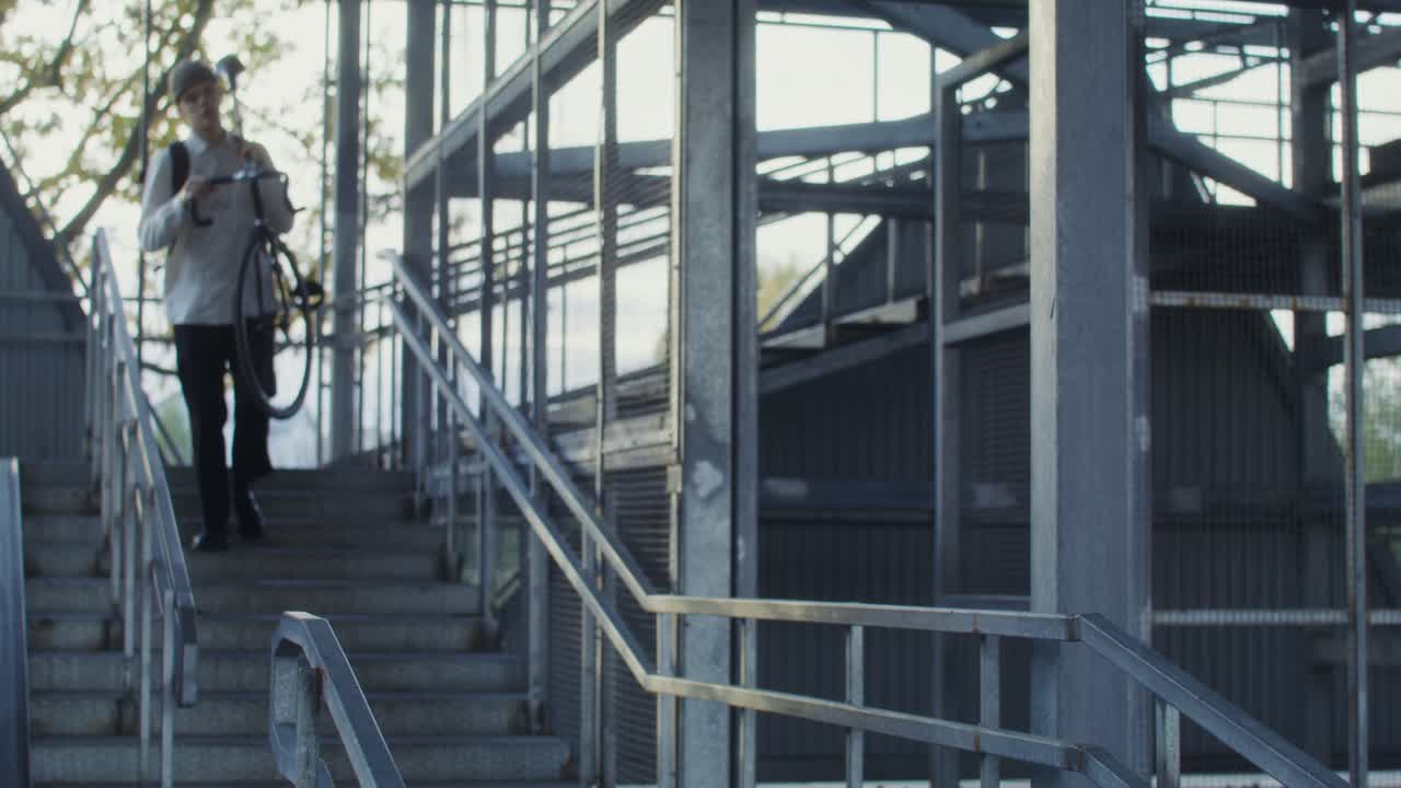Young Man with Bicycle on Stairs in Urban Environment