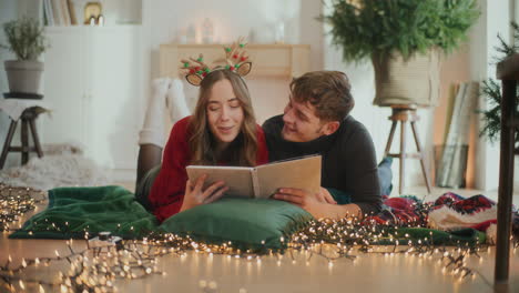 heterosexual couple looking at photo album