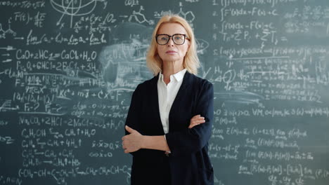 teacher in front of a chalkboard filled with mathematical equations