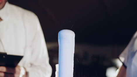 woman scientist mixing together two liquid substances. experiments in a chemistry lab. close-up