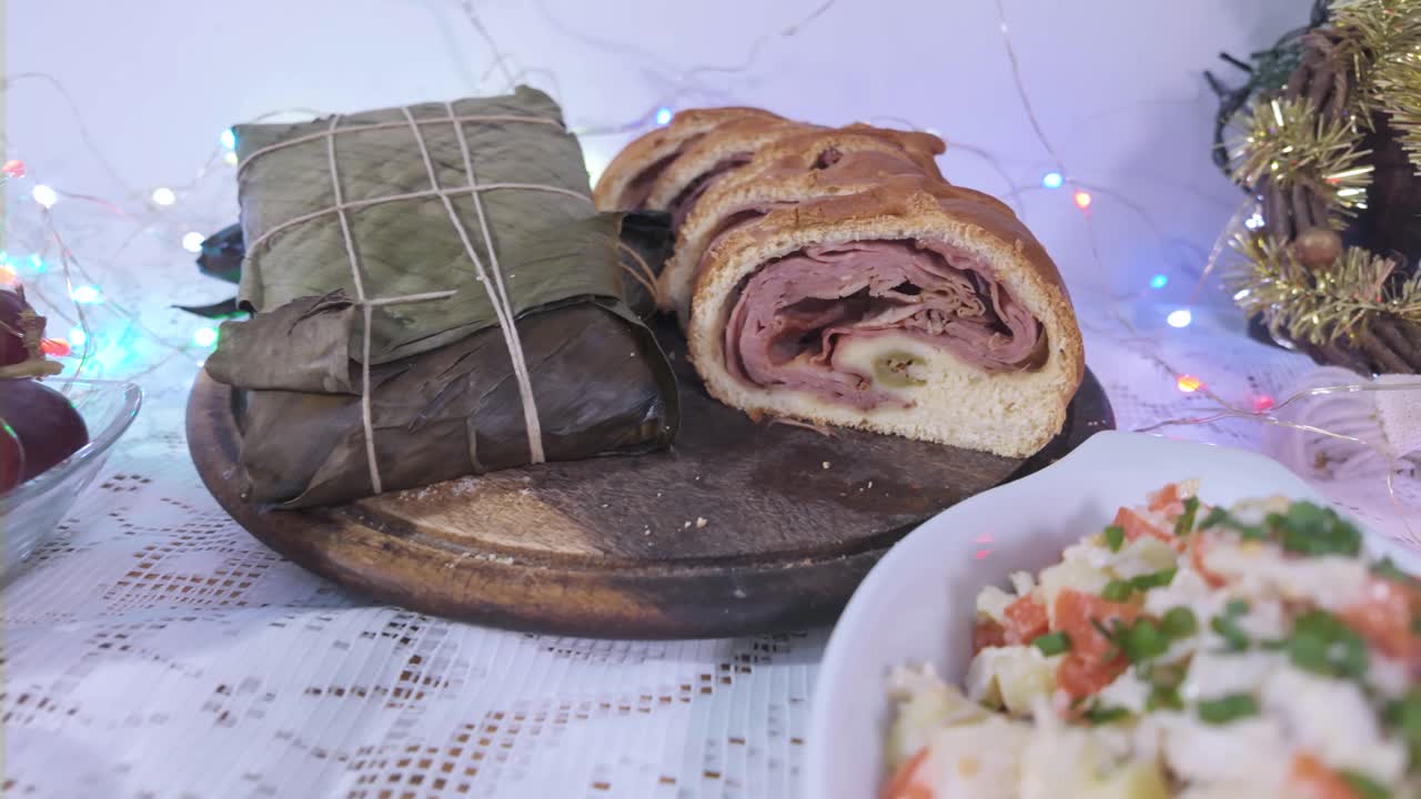 Festive Venezuelan holiday food pan de jamon and hallacas on the table