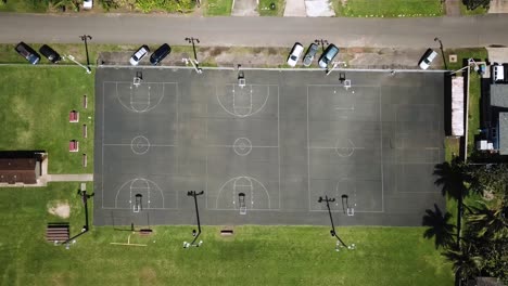 closed basketball courts at laie park, hawaii, lowering aerial birds eye view