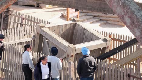 group observes historical mining bucket and crate