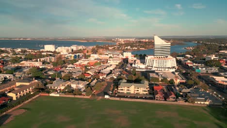 Aerial-View-Of-Bunbury-Tower,-Urban-Australian-Landmark-and-Surrounding-Neighborhoods-At-Sunset