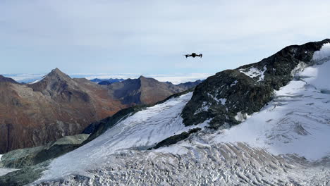 Saas-Fee-Saastal-summer-autumn-fall-dirty-brown-glacier-drone-flight-flying-over-Switzerland-Swiss-Alps-alpine-valley-Zermatt-Alphabet-Taschhorn-stunning-peaks-mid-day-sunny-static-shot