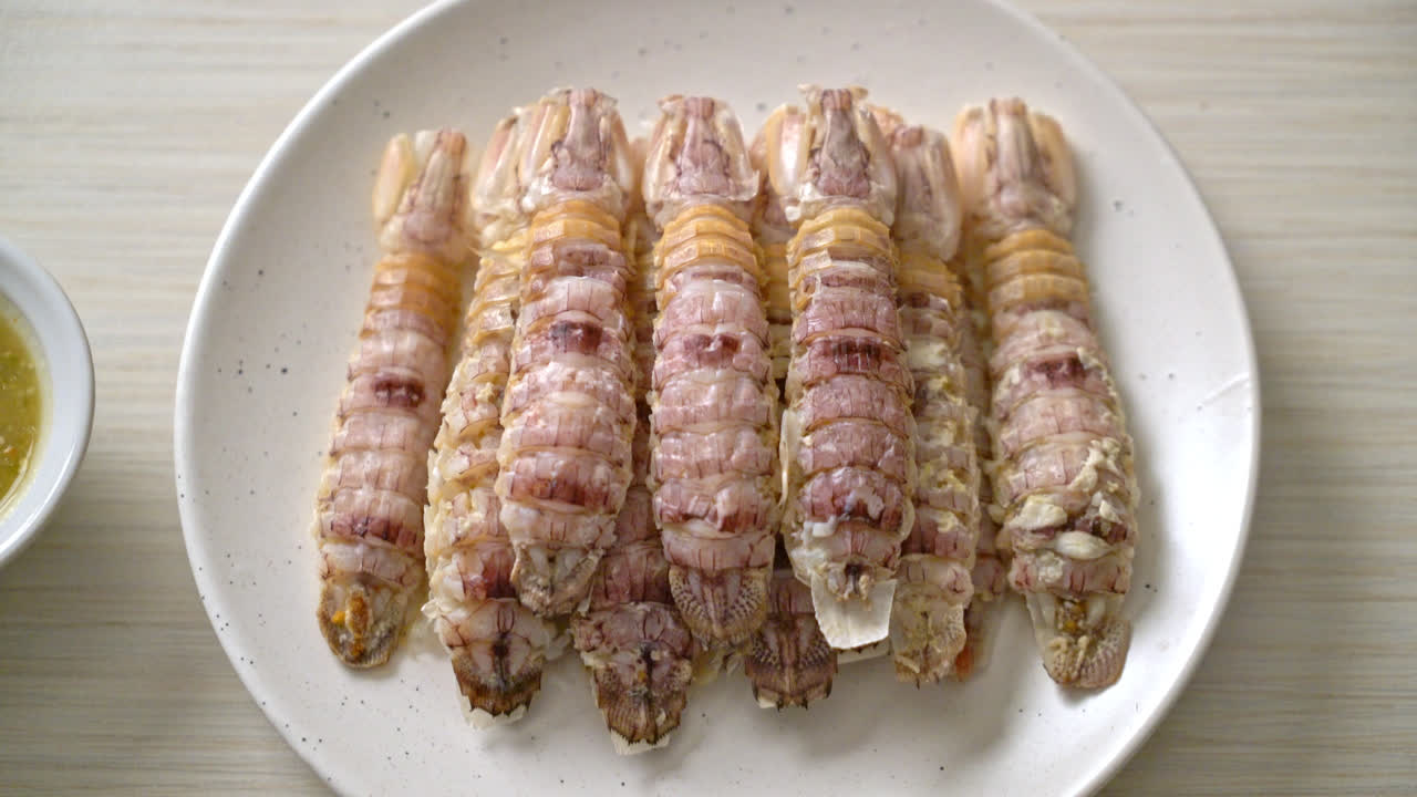 찐 가재 또는 사마귀 새우 또는 매운 해산물 소스를 곁들인 스토마토포드